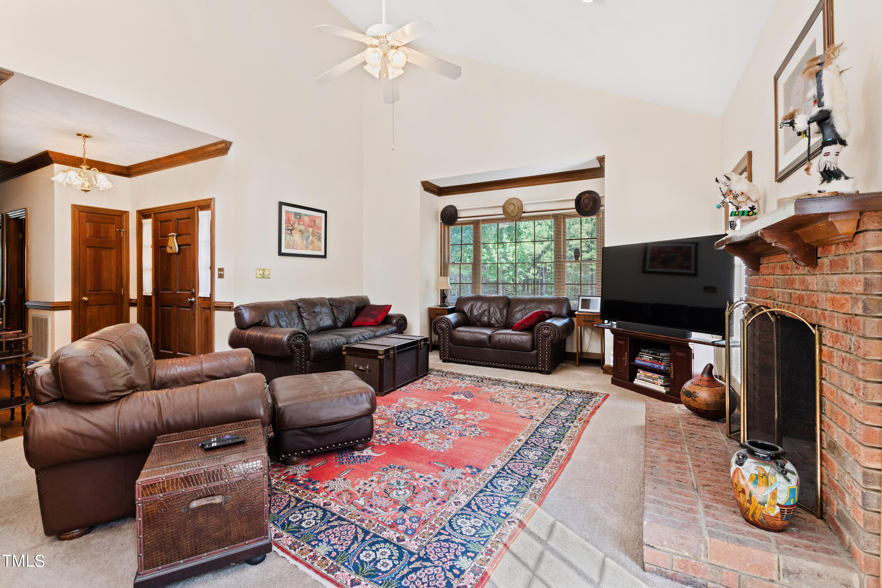 8450 Wycombe Lane Raleigh, NC 27615 - Photo 12 of 32 a living room with furniture a flat screen tv and a fireplace