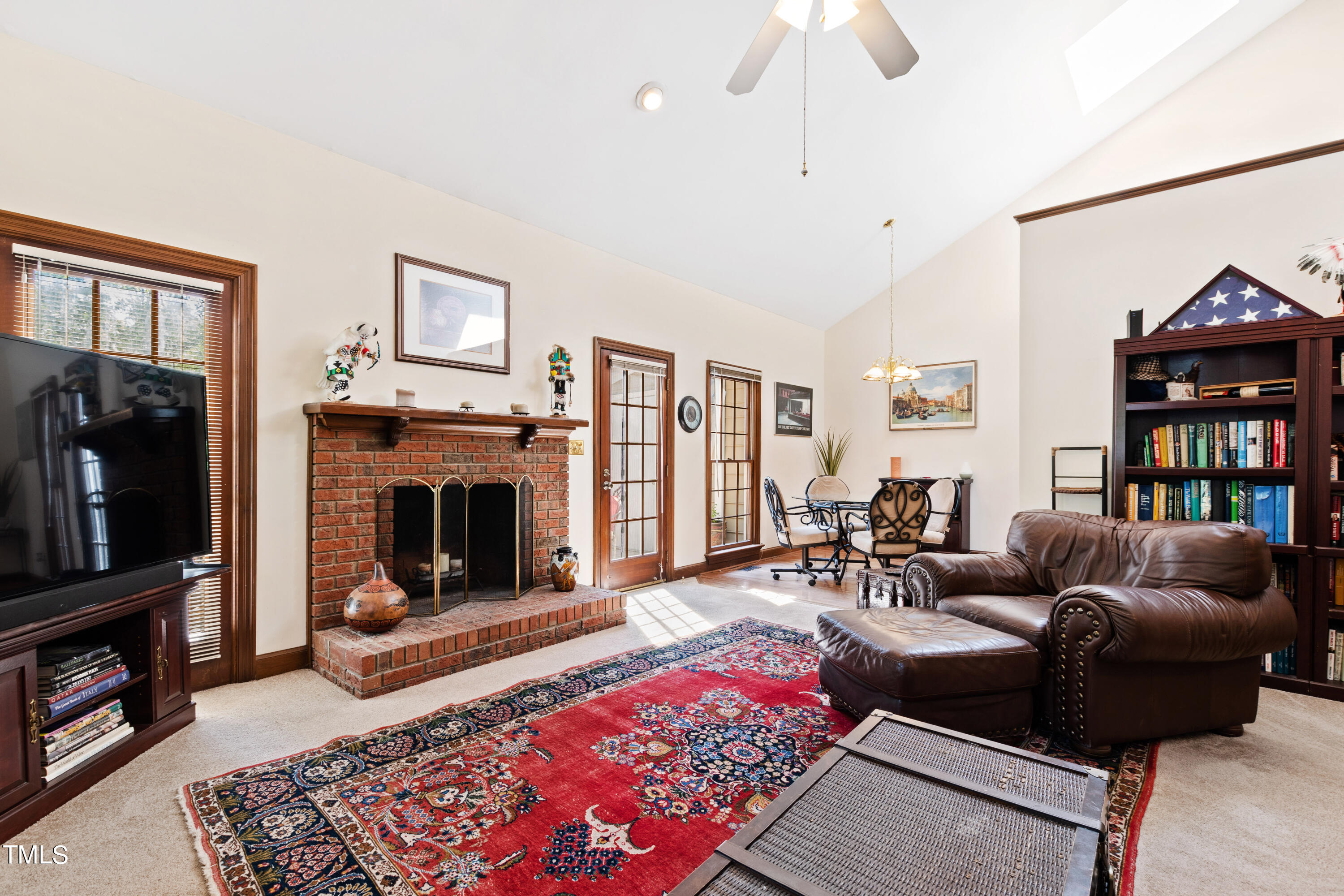 8450 Wycombe Lane Raleigh, NC 27615 - Photo 14 of 32 a living room with furniture a flat screen tv and a fireplace