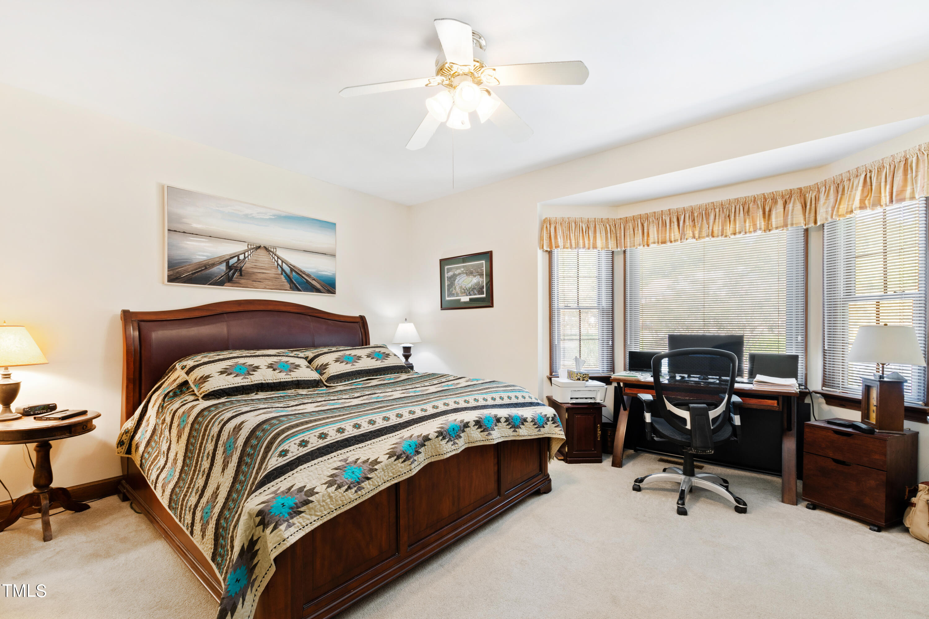 8450 Wycombe Lane Raleigh, NC 27615 - Photo 16 of 32 a bedroom with a bed and a chandelier