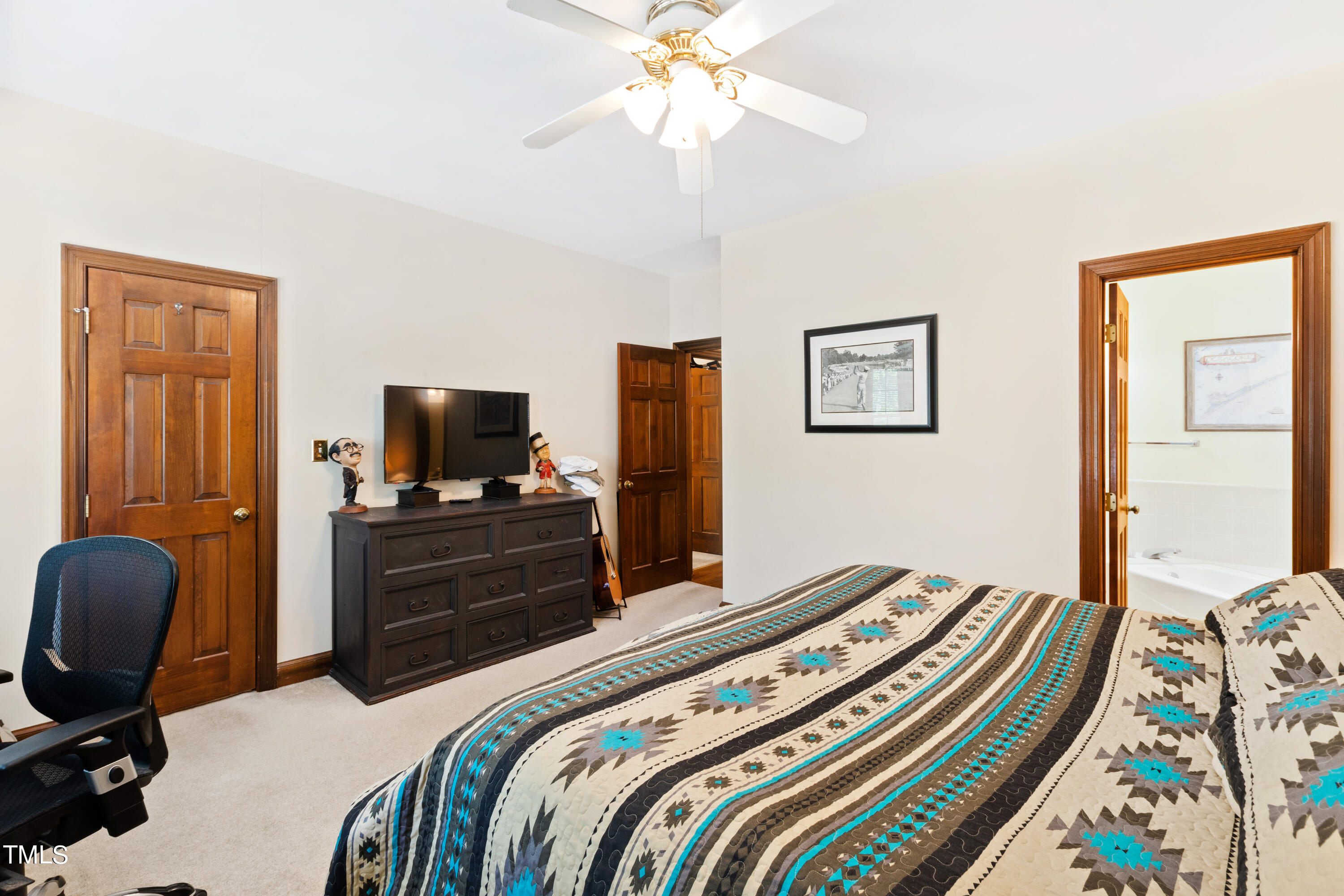 8450 Wycombe Lane Raleigh, NC 27615 - Photo 17 of 32 a bedroom with a bed and a flat screen tv