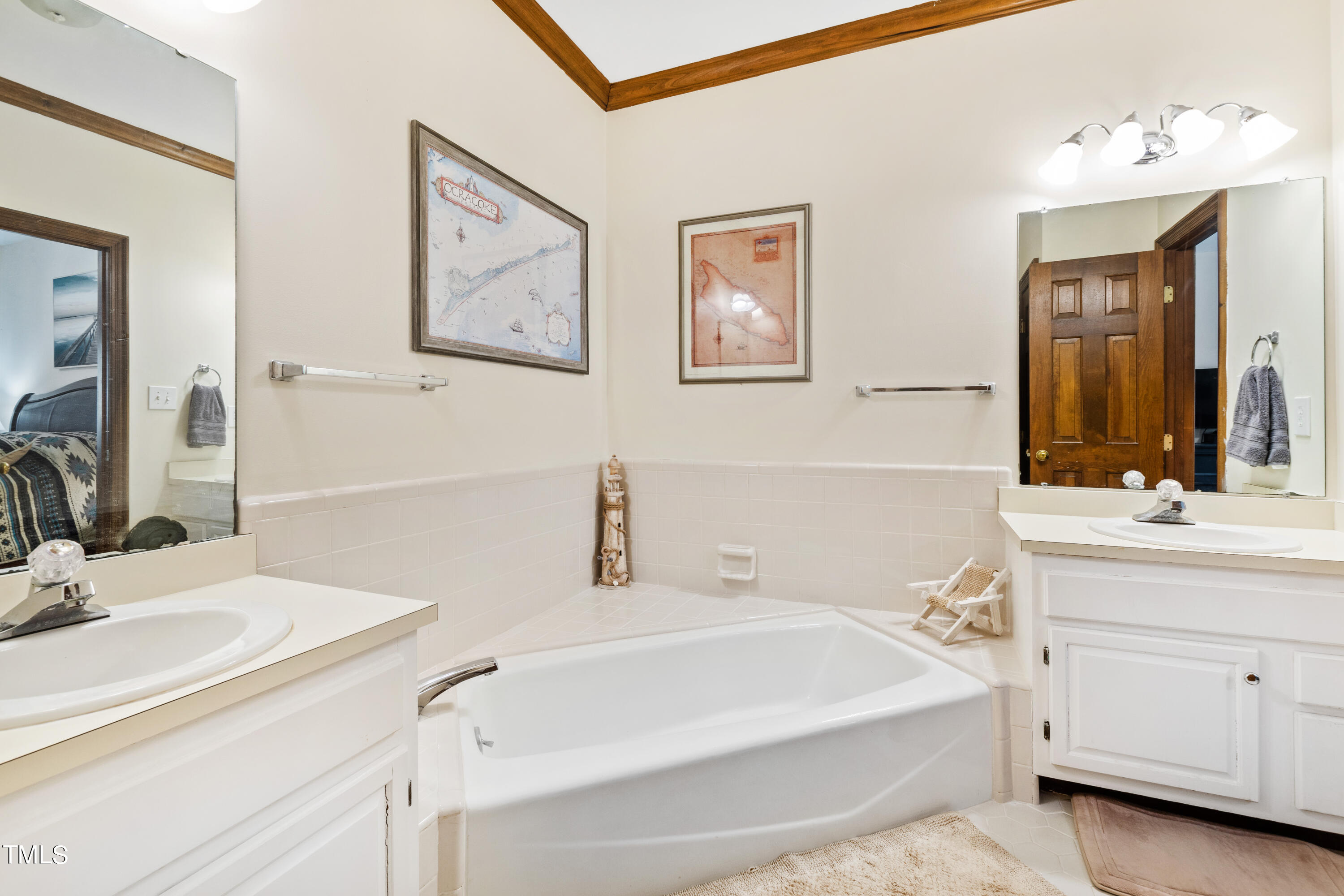 8450 Wycombe Lane Raleigh, NC 27615 - Photo 18 of 32 a bathroom with a tub sink and mirror