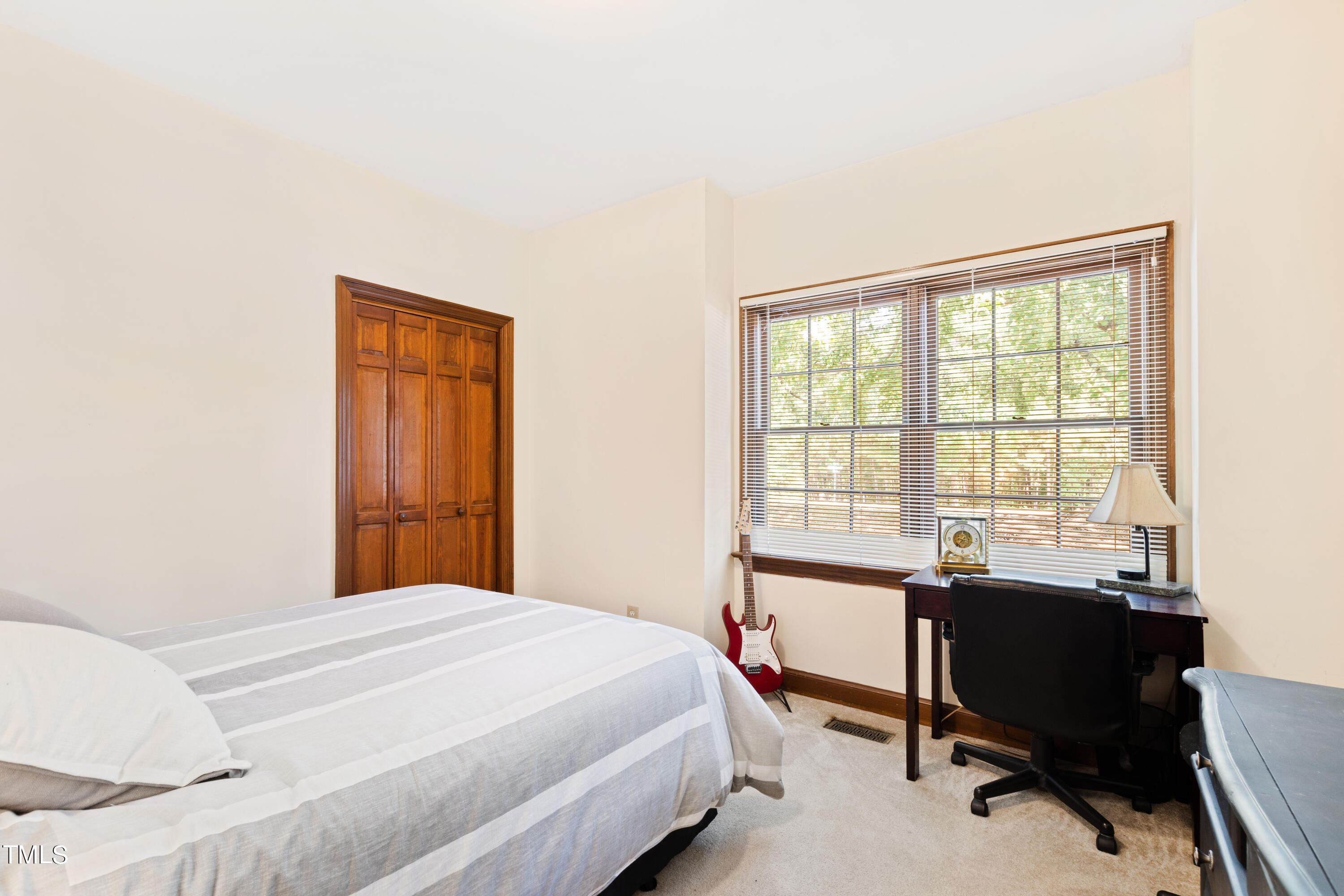 8450 Wycombe Lane Raleigh, NC 27615 - Photo 20 of 32 a bedroom with a bed and a table