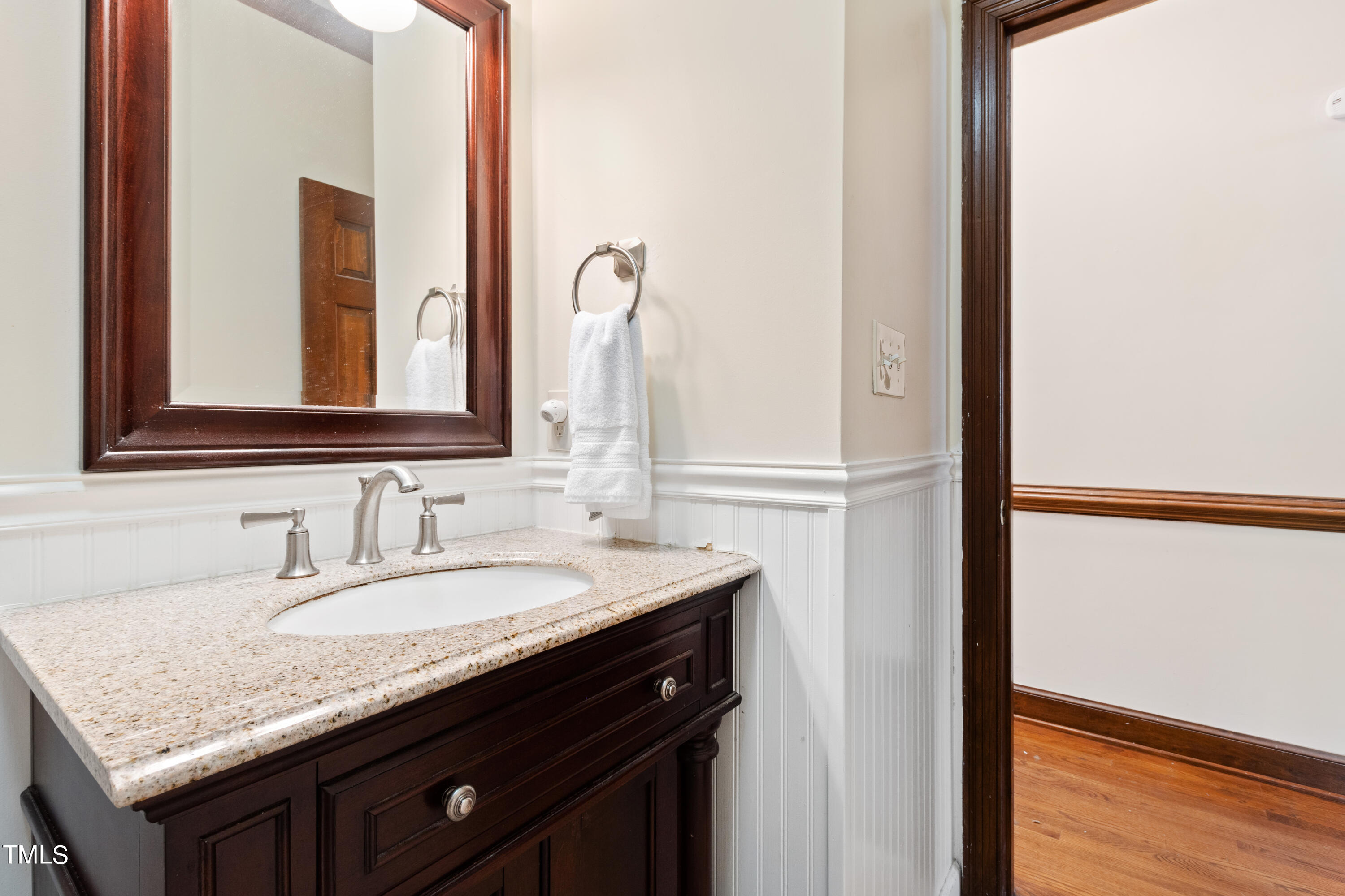 8450 Wycombe Lane Raleigh, NC 27615 - Photo 22 of 32 a bathroom with a granite countertop sink and a mirror