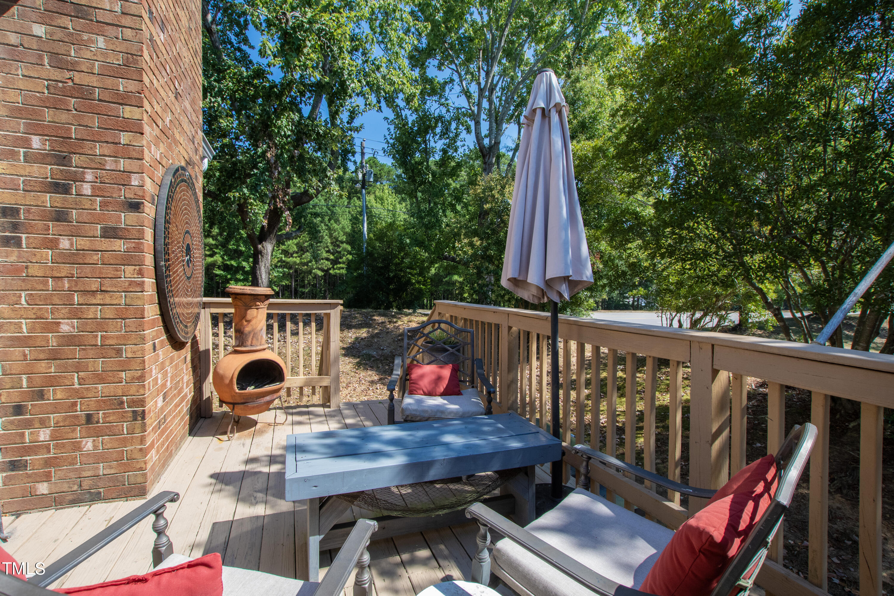 8450 Wycombe Lane Raleigh, NC 27615 - Photo 27 of 32 a view of a deck with a table and chairs a barbeque with wooden floor and fence