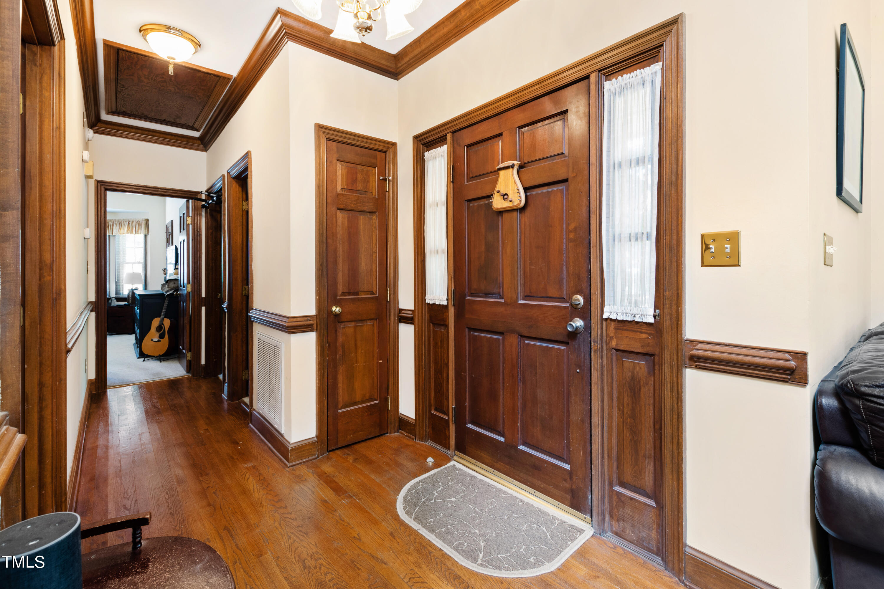 8450 Wycombe Lane Raleigh, NC 27615 - Photo 3 of 32 a view of a hallway with wooden floor and staircase