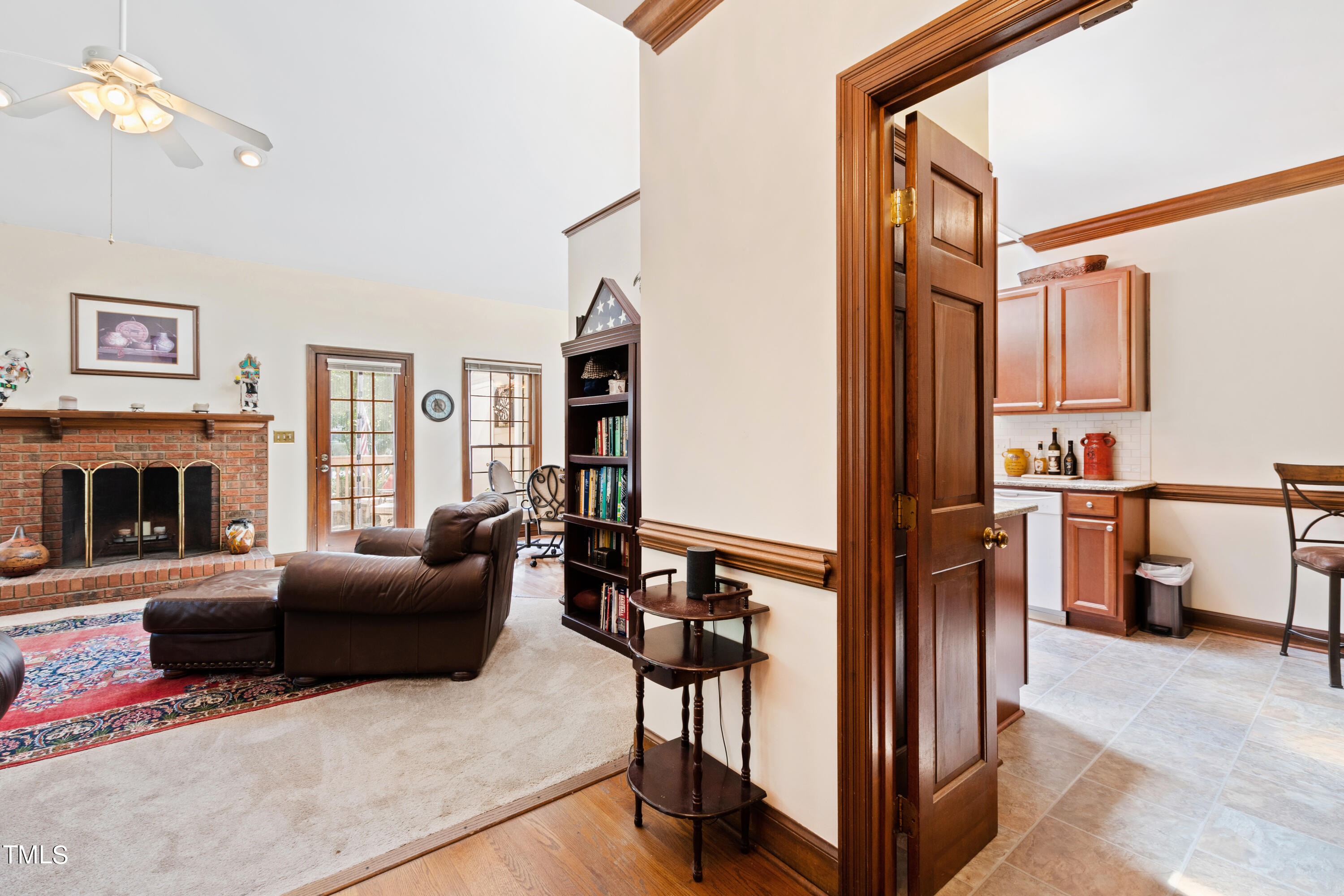 8450 Wycombe Lane Raleigh, NC 27615 - Photo 5 of 32 a living room with furniture a fireplace and a flat screen tv