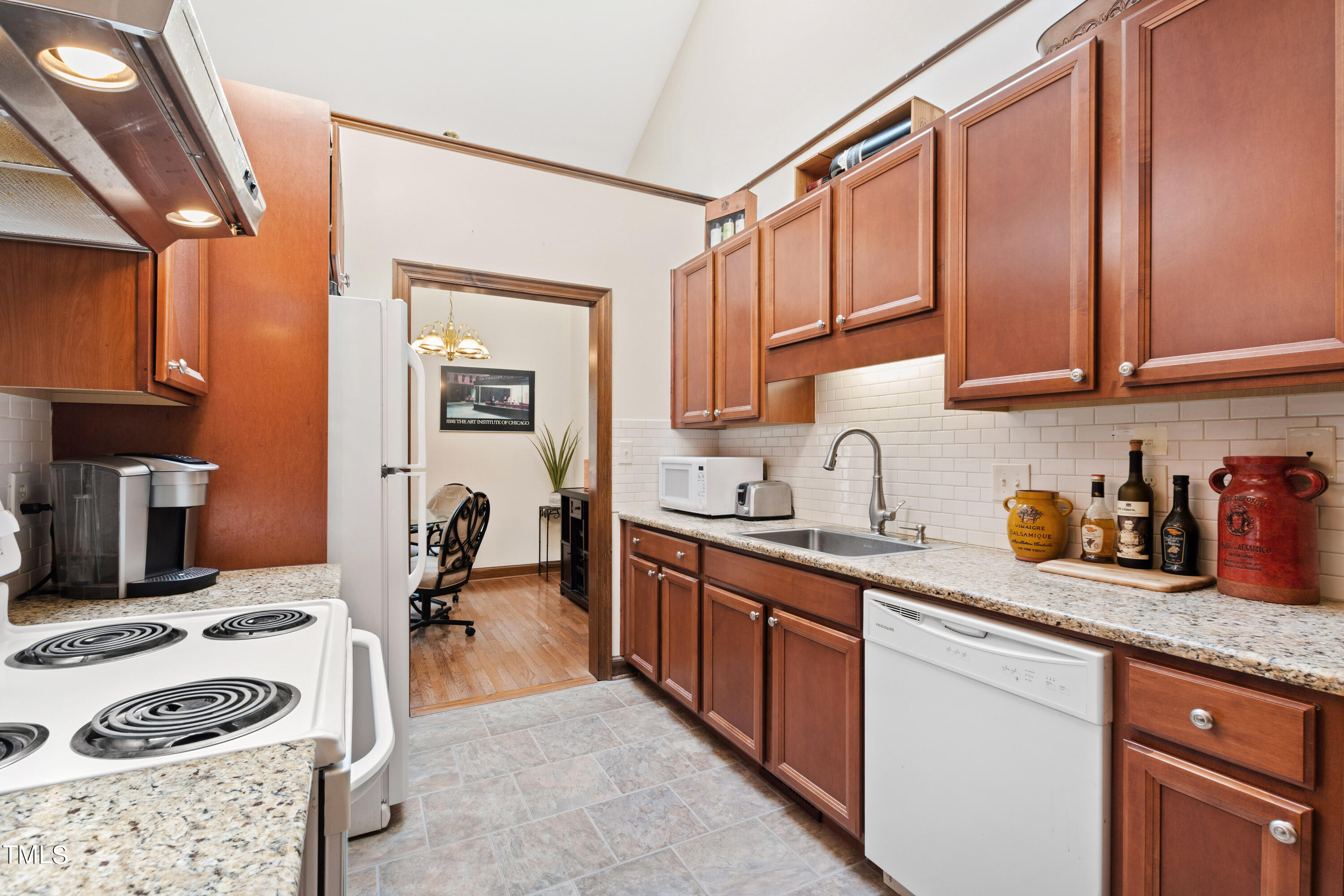 8450 Wycombe Lane Raleigh, NC 27615 - Photo 6 of 32 a kitchen with a sink a stove and cabinets