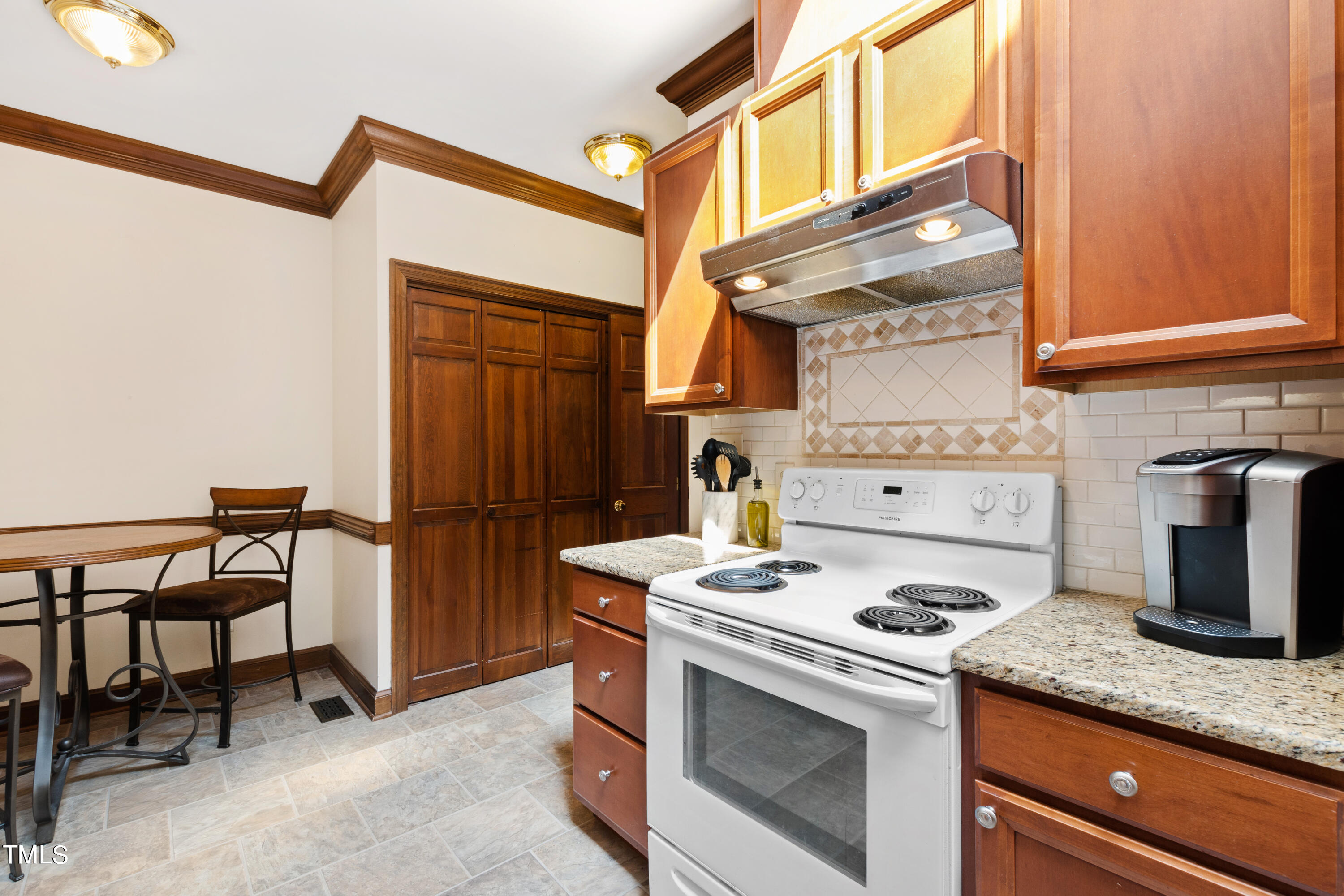 8450 Wycombe Lane Raleigh, NC 27615 - Photo 8 of 32 a kitchen with a stove and a refrigerator