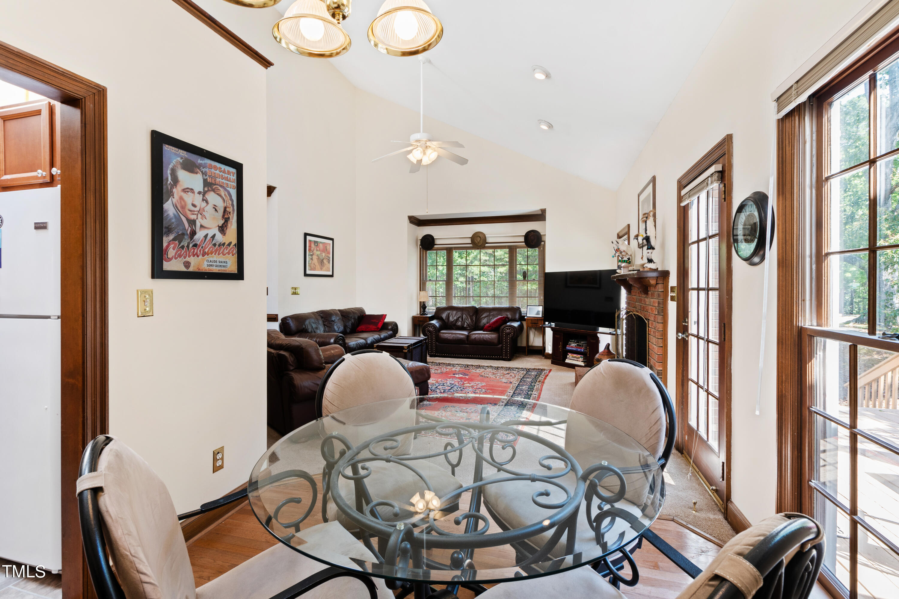 8450 Wycombe Lane Raleigh, NC 27615 - Photo 10 of 32 a living room with furniture a fireplace and a flat screen tv