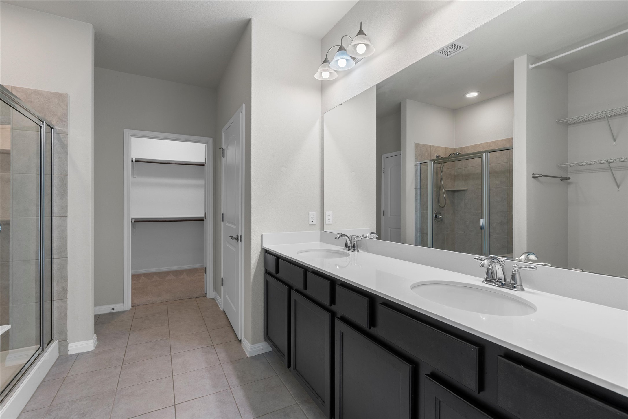 108 Calhoun Lane Georgetown, TX 78633 - Photo 18 of 32 a bathroom with a double vanity sink a mirror and a shower