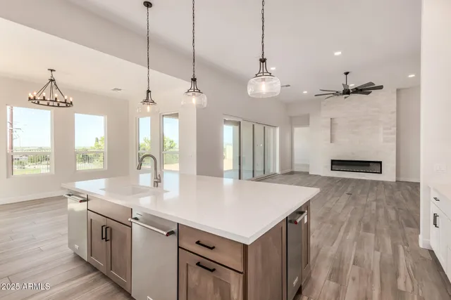 a kitchen with stainless steel appliances granite countertop a stove and a refrigerator
