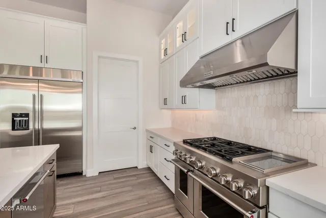 a room with walk in closet with empty racks