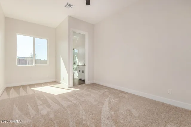 an empty room with large window and mirror