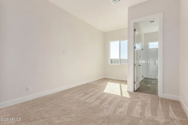 a bathroom with a granite countertop sink a toilet and a mirror
