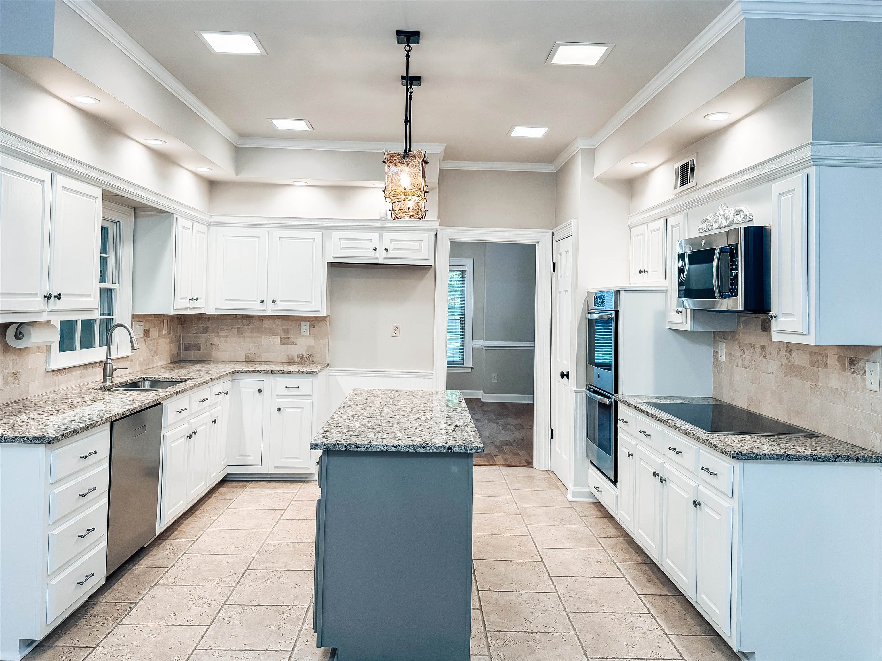 832 South Tree Drive Collierville, TN 38017 - Photo 14 of 40 Bright kitchen featuring white cabinetry and light-colored granite countertops