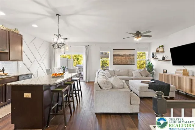 a view of a dining room with furniture a chandelier and wooden floor