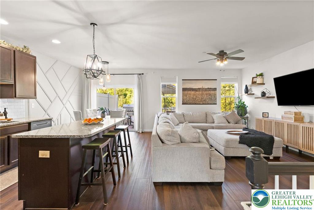 312 Redclover Lane Allentown, PA 18104 - Photo 11 of 60 a living room with furniture a chandelier and a flat screen tv