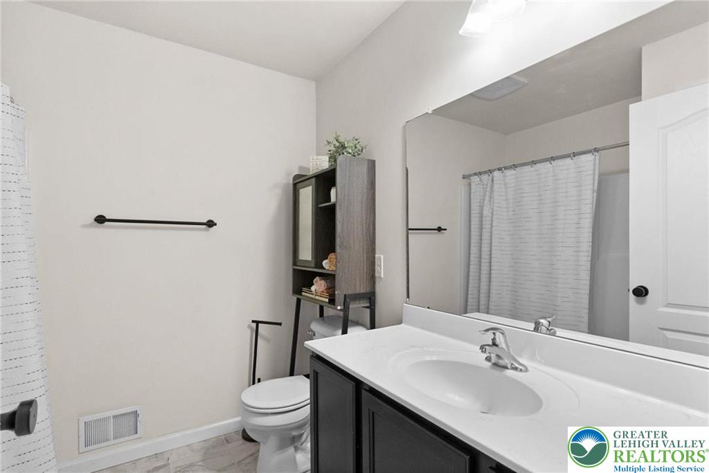 312 Redclover Lane Allentown, PA 18104 - Photo 27 of 60 a bathroom with a sink a toilet and shower curtain