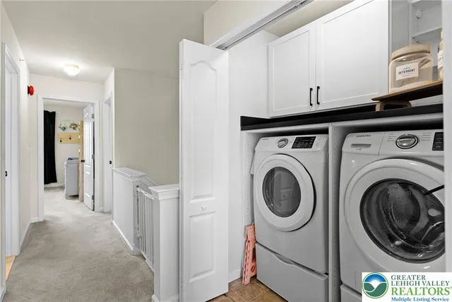 a spacious bedroom with a bed and a flat tv screen