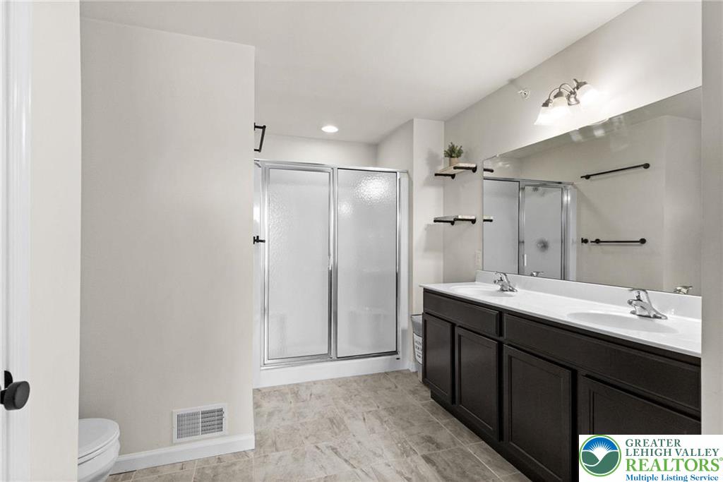 312 Redclover Lane Allentown, PA 18104 - Photo 37 of 60 a bathroom with a sink a toilet a shower and a mirror