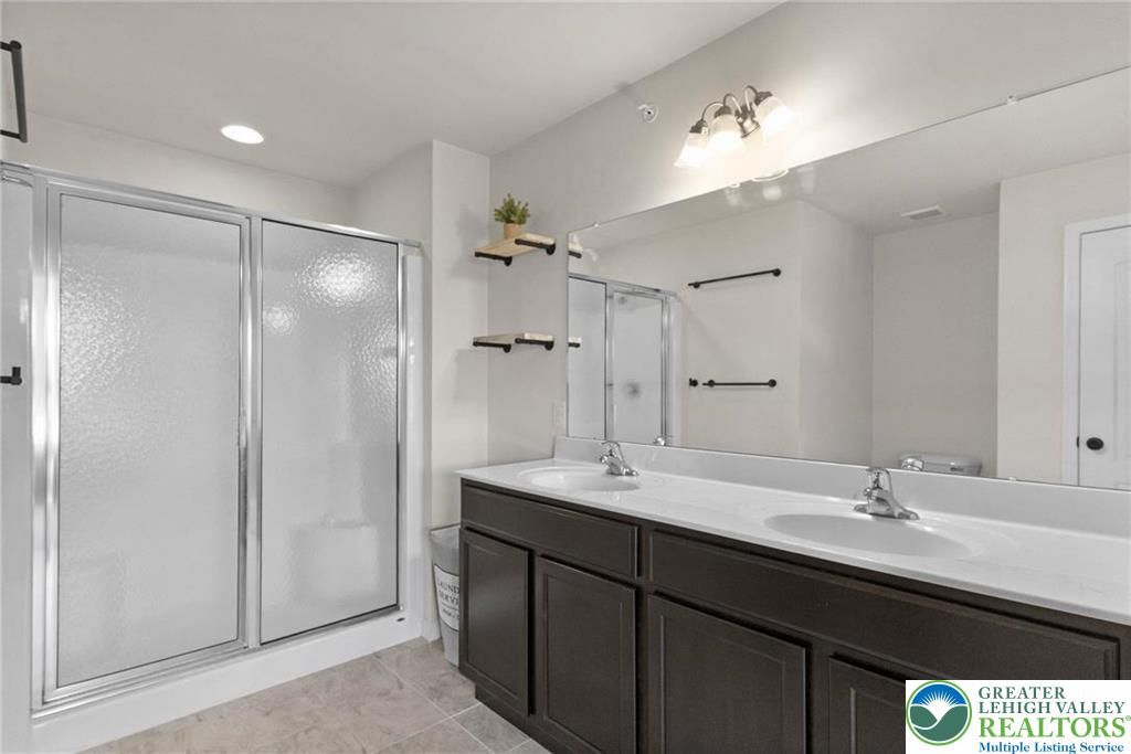 312 Redclover Lane Allentown, PA 18104 - Photo 39 of 60 a bathroom with a sink double vanity granite tub shower and a mirror