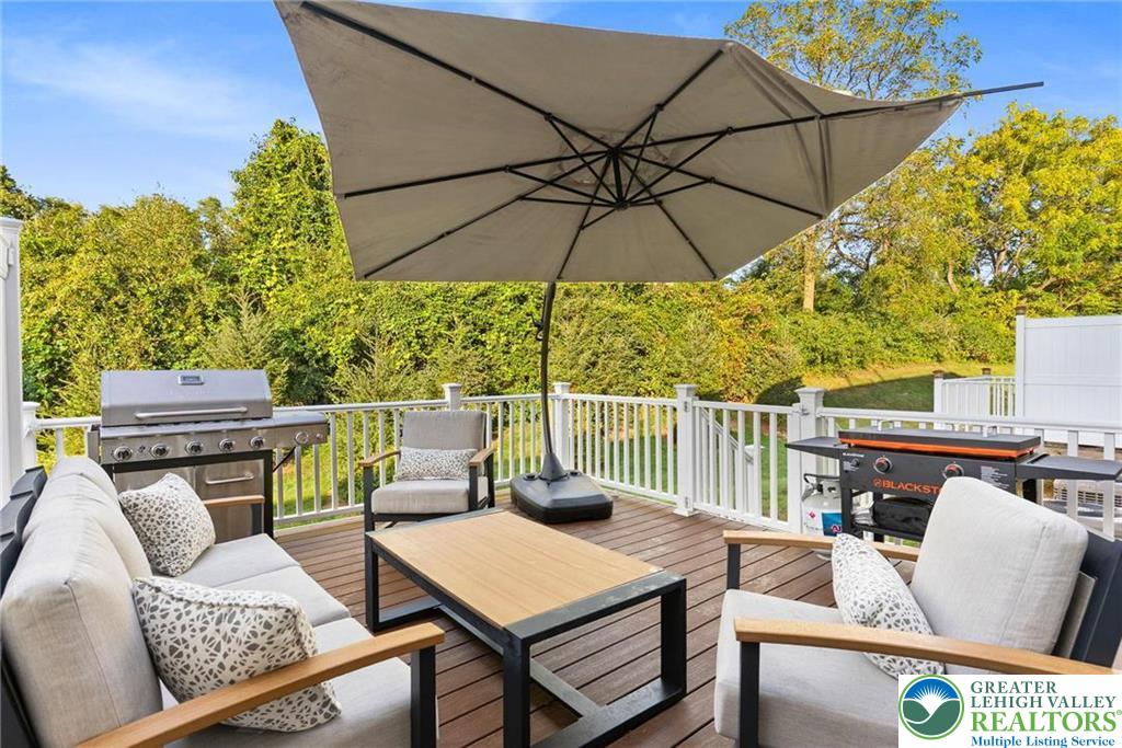 312 Redclover Lane Allentown, PA 18104 - Photo 49 of 60 a view of a patio with a table and chairs under an umbrella