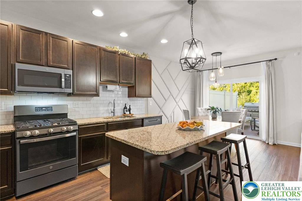 312 Redclover Lane Allentown, PA 18104 - Photo 8 of 60 a kitchen with stainless steel appliances granite countertop a stove a sink a microwave a center island and cabinets