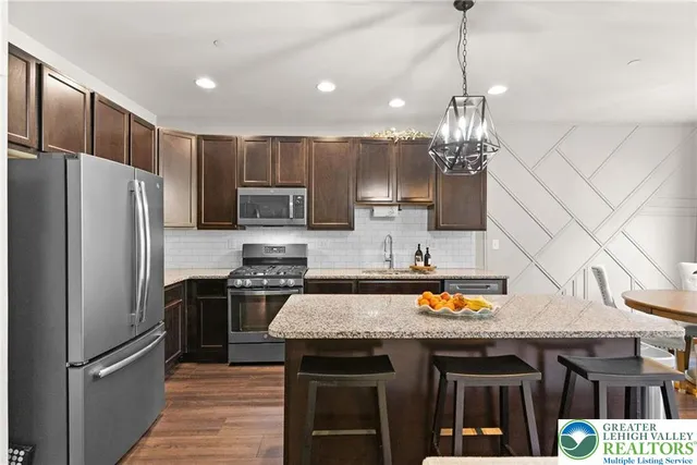 a living room with furniture a chandelier and a flat screen tv