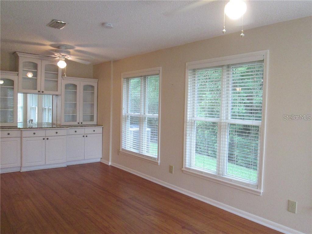 14873 Feather Cove Road Clearwater, FL 33762 - Photo 11 of 25 a view of an empty room with wooden floor and a window