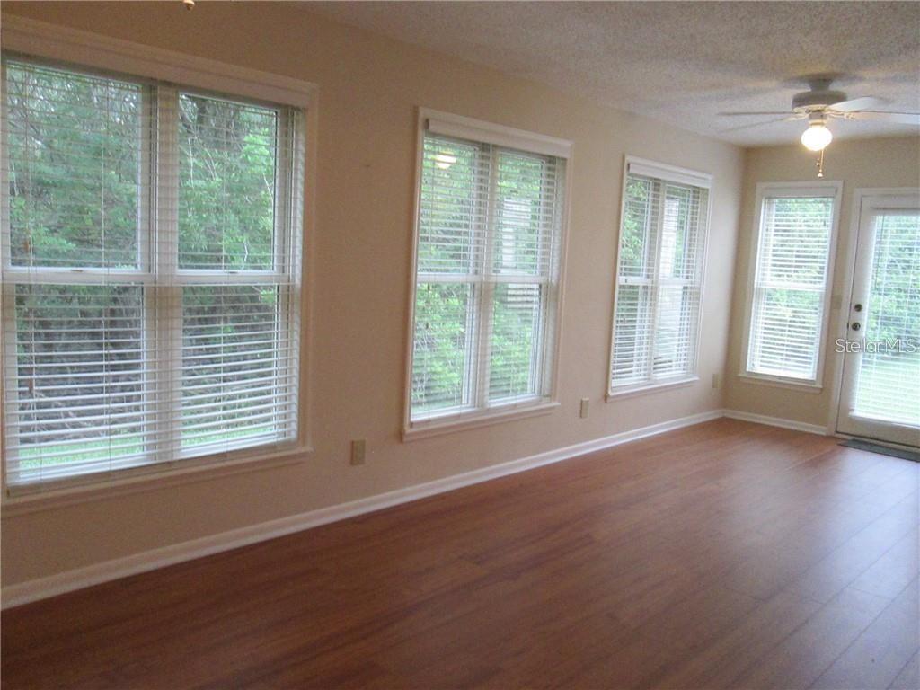 14873 Feather Cove Road Clearwater, FL 33762 - Photo 12 of 25 a view of an empty room with wooden floor and a window