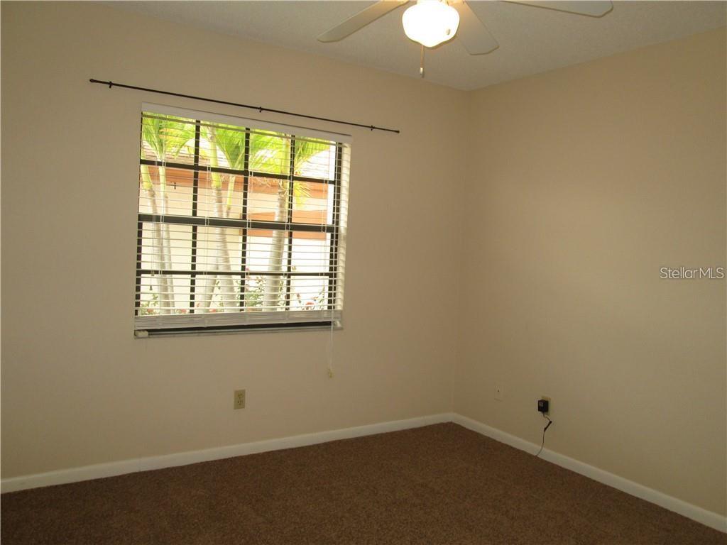 14873 Feather Cove Road Clearwater, FL 33762 - Photo 13 of 25 an empty room with a window
