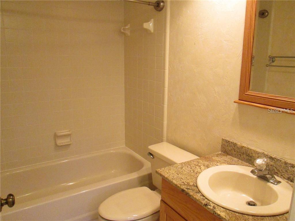 14873 Feather Cove Road Clearwater, FL 33762 - Photo 15 of 25 a bathroom with a toilet sink and bathtub