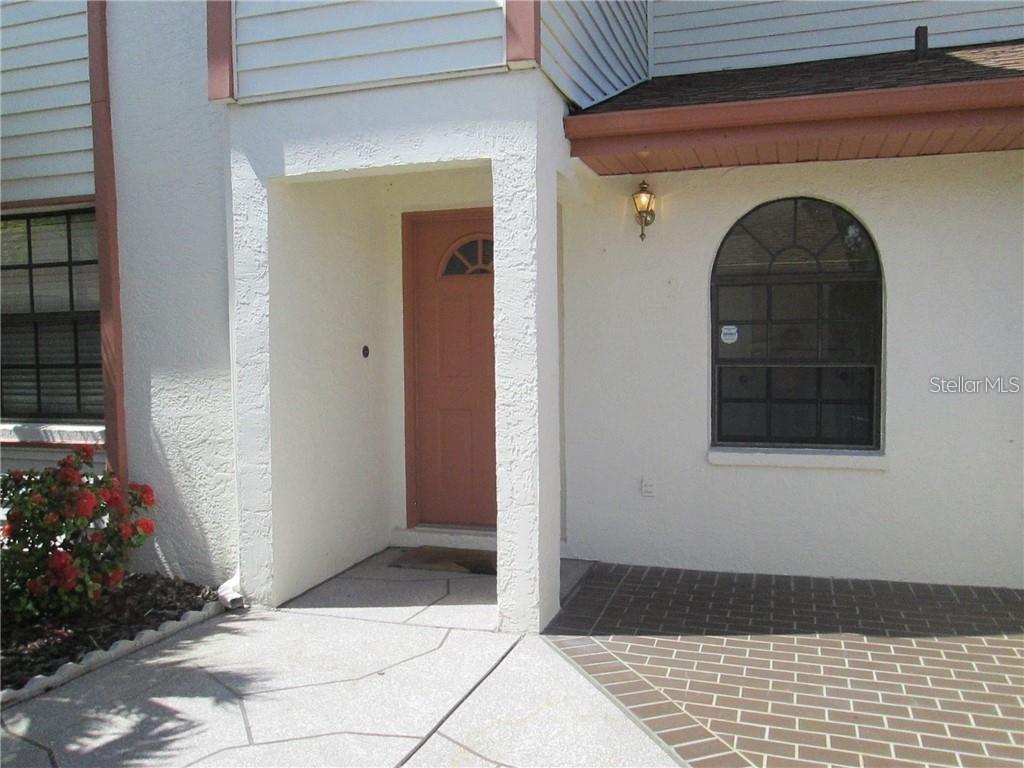 14873 Feather Cove Road Clearwater, FL 33762 - Photo 2 of 25 a view of a wooden door of the house