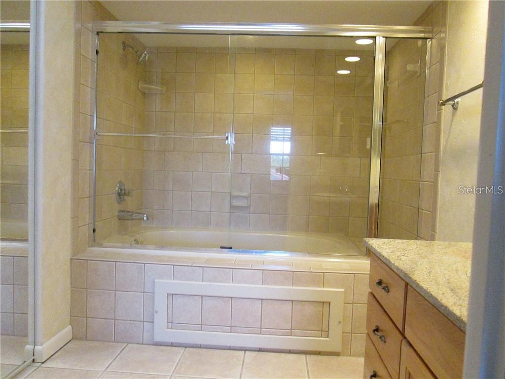 14873 Feather Cove Road Clearwater, FL 33762 - Photo 22 of 25 a bathroom with a shower and a sink