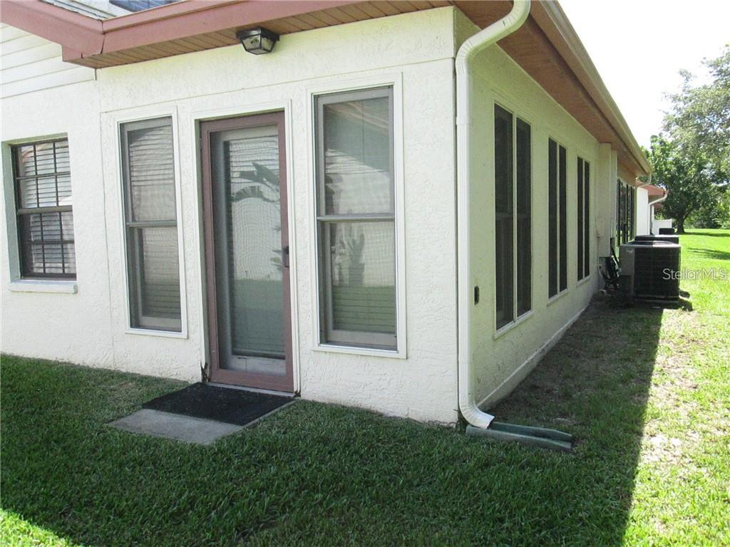 14873 Feather Cove Road Clearwater, FL 33762 - Photo 24 of 25 a view of front door of house and yard