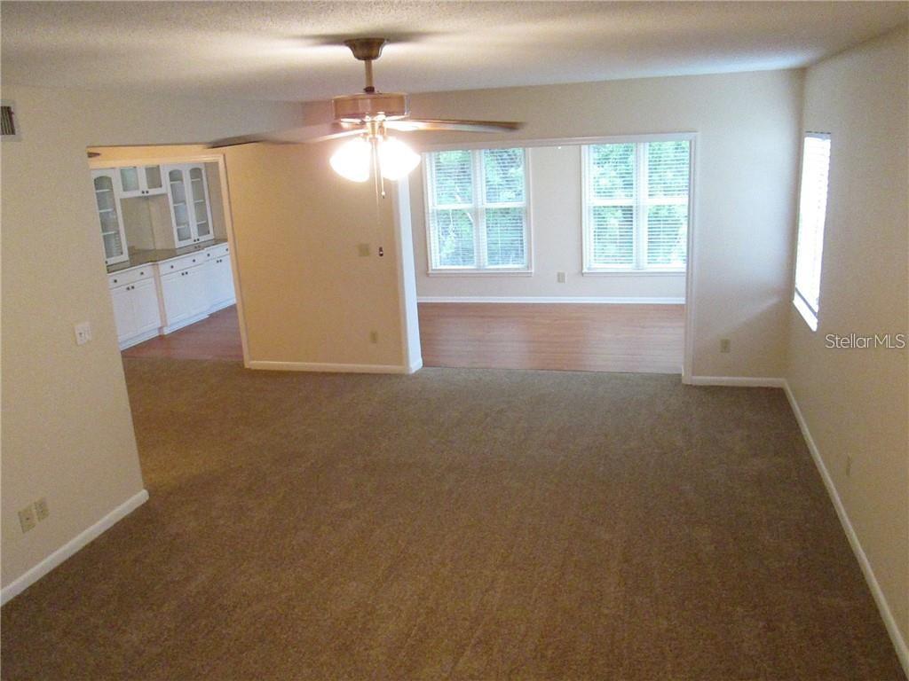 14873 Feather Cove Road Clearwater, FL 33762 - Photo 4 of 25 an empty room with windows and entrance