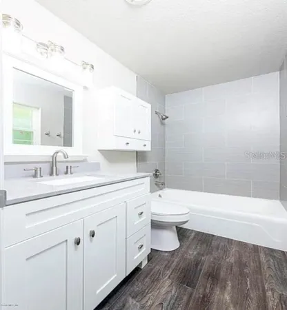 a bathroom with a toilet a sink and bathtub