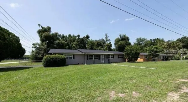 a view of a house with a yard and a garden