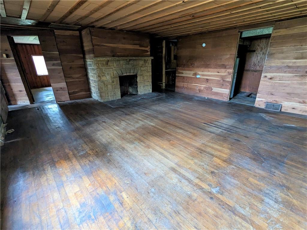2041 Dinner Bell - 5 Forks Road Farmington, PA 15437 - Photo 5 of 10 an empty room with wooden floor and fireplace