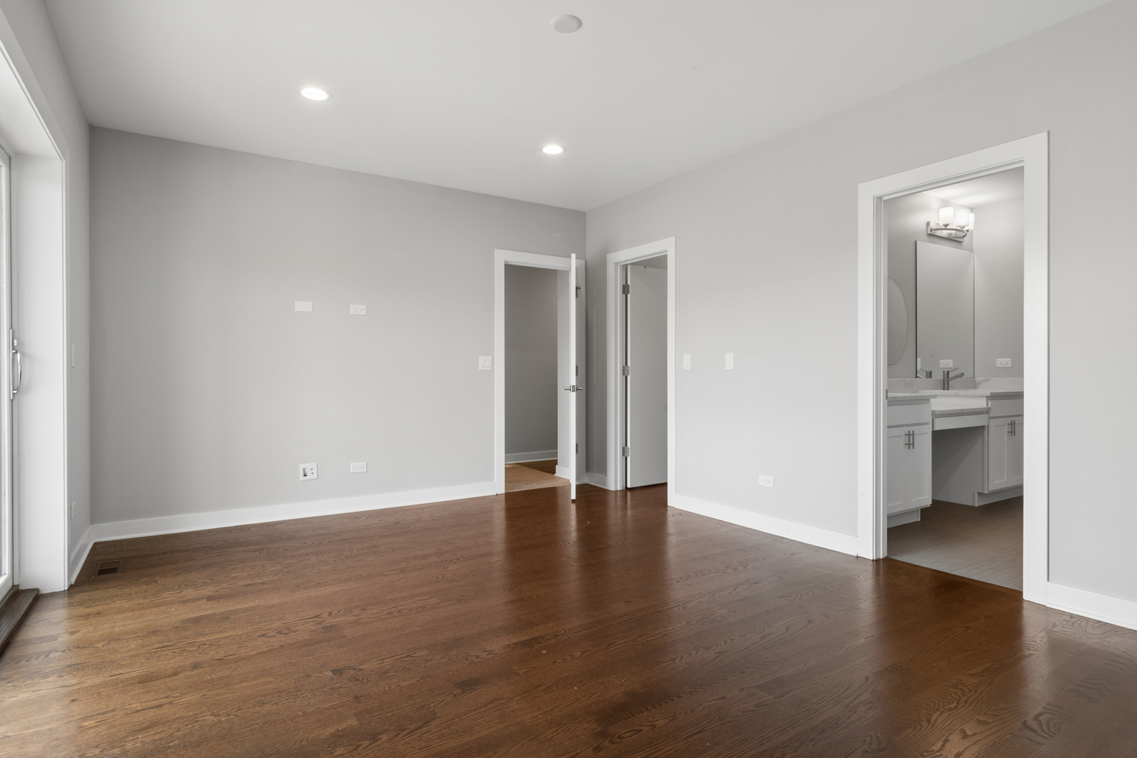 4845 North Keystone Avenue, Unit 2N Chicago, IL 60630 - Photo 11 of 21 a view of an empty room with a window and wooden floor