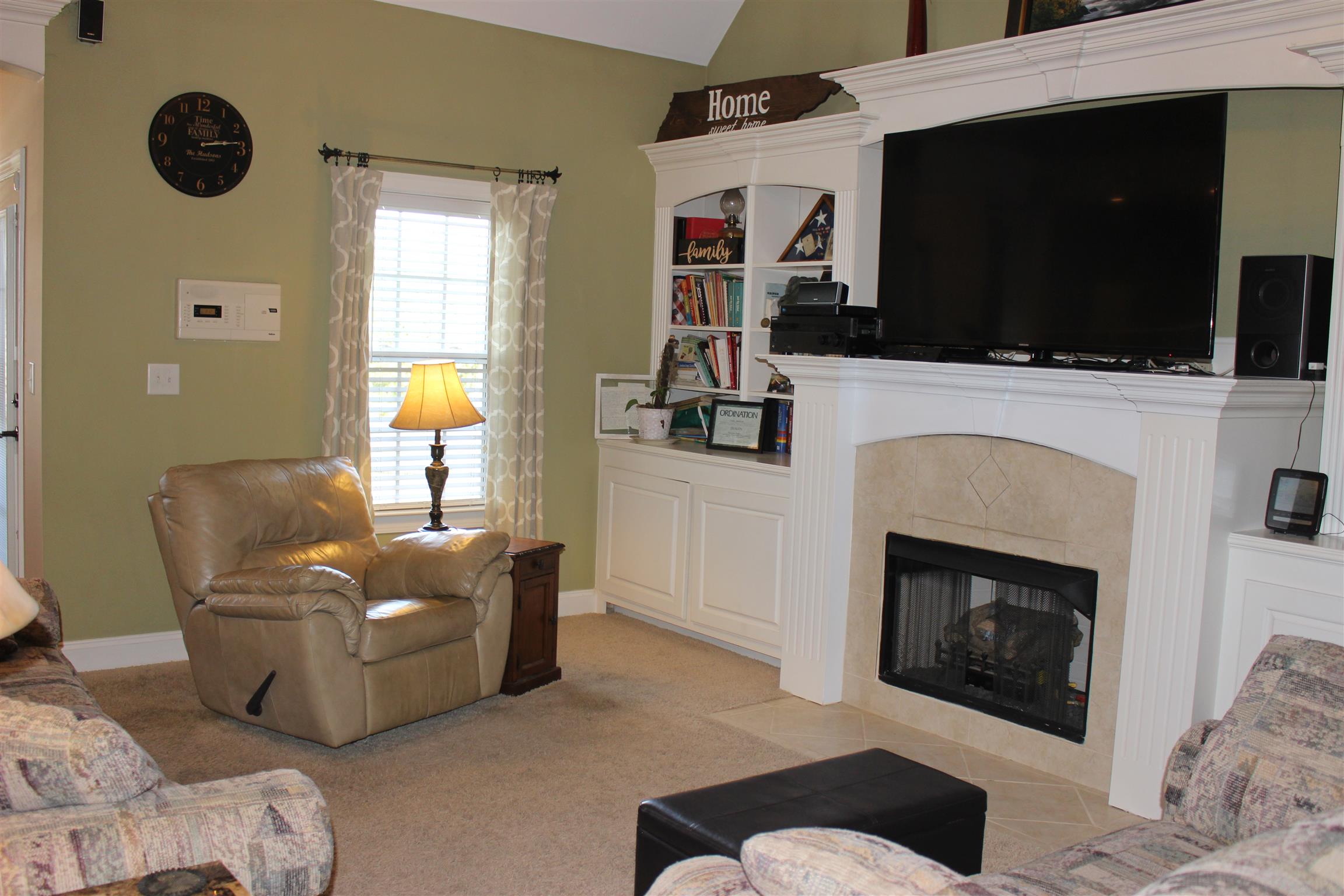 116 New Dawn Road Rockvale, TN 37153 - Photo 11 of 26 a living room with furniture a flat screen tv and a fireplace