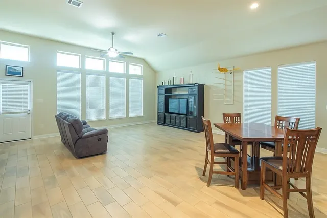 a bathroom with a granite countertop bathtub sink vanity mirror and toilet
