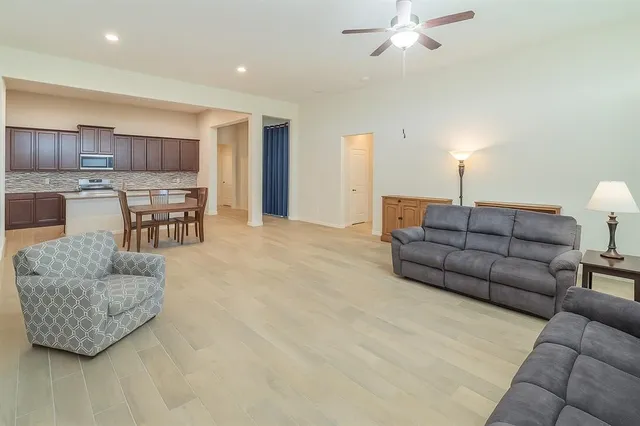 a living room with stainless steel appliances kitchen island granite countertop furniture and a kitchen view