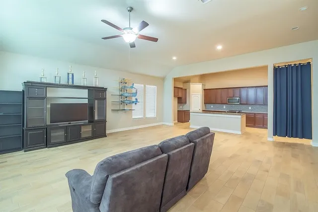 a kitchen with sink and view of living room