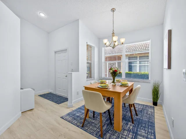 a dining room with furniture and window