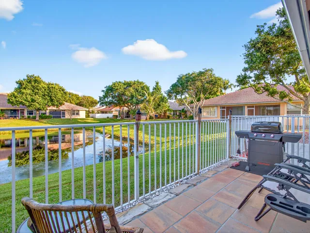 a view of a house with backyard and outdoor seating