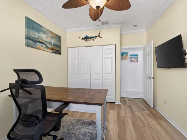 a view of a workspace with furniture and wooden floor
