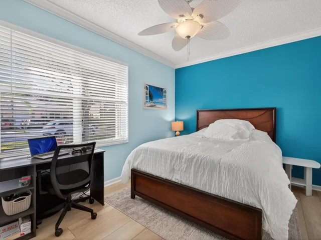 a bedroom with a bed and a desk