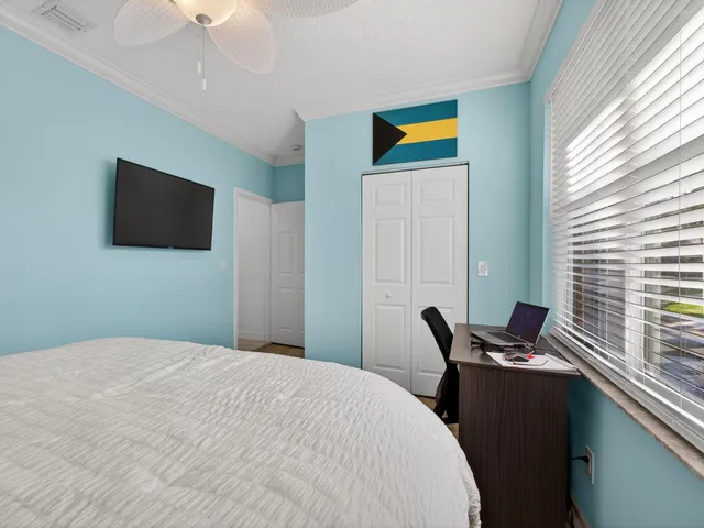 a bedroom with a bed and a television