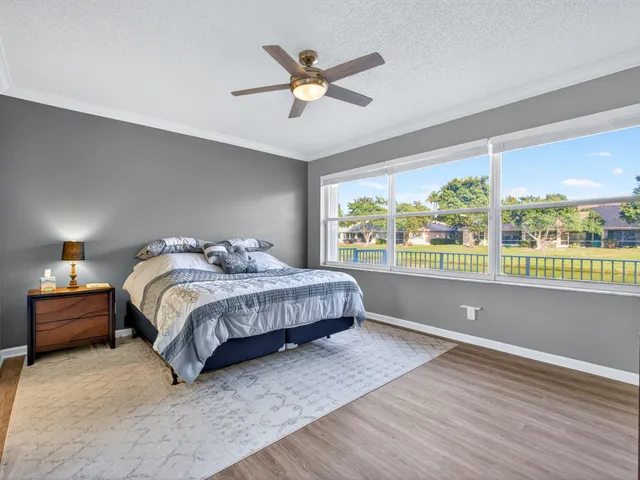 a bedroom with a large bed and a large window
